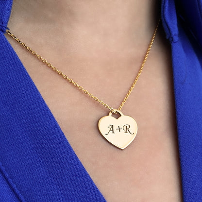 Handcrafted sterling silver heart tag necklace that can be customized with a single initial, double initials or an inscription of your choice.