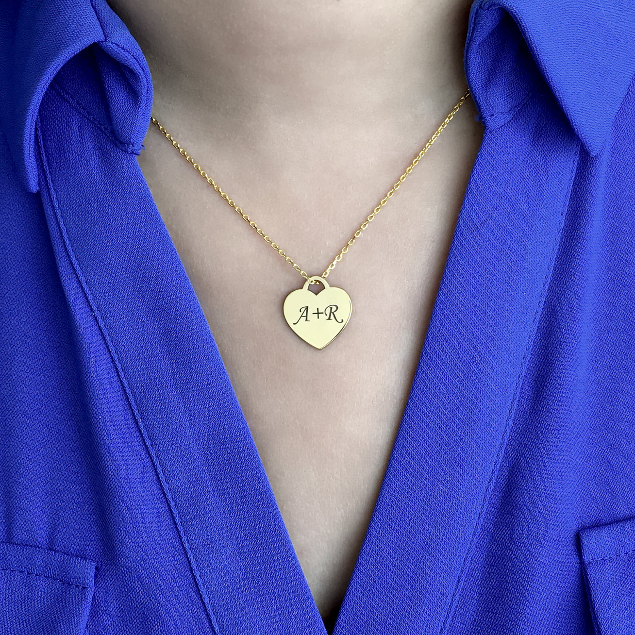 Handcrafted sterling silver heart tag necklace that can be customized with a single initial, double initials or an inscription of your choice.